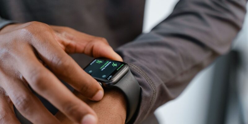 A detailed view of a smartwatch tracking fitness on a person's wrist.